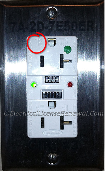 The TR on the receptacle indicates that the receptacle is tamper-resistant.