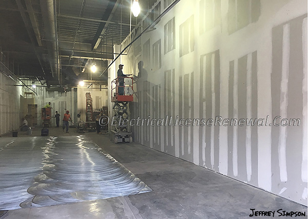 Notice that the demising wall between adjoining occupancies is framed clear to the under-side of the roof deck. This 2-hour fire rated wall separates the two occupancies and according to the Building Code, creates two separate occupancies altogether.