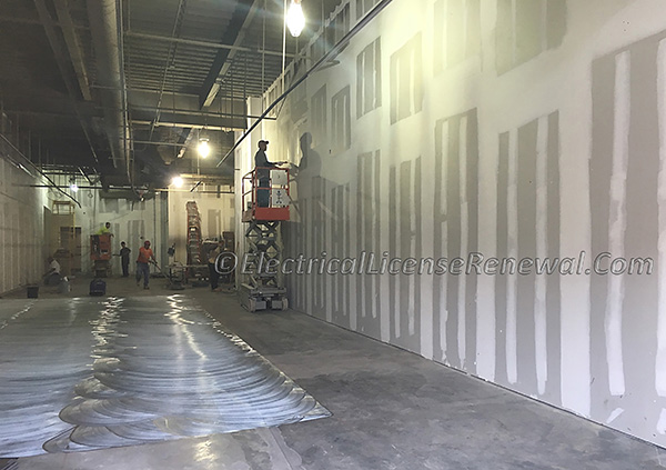 Notice that the demising wall between adjoining occupancies is framed clear to the under-side of the roof deck. This 2-hour fire rated wall separates the two occupancies and according to the Building Code, creates two separate occupancies altogether.