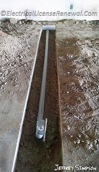 PVC conduit being installed under slab for a new car lift at a commercial repair garage. Is this code compliant?